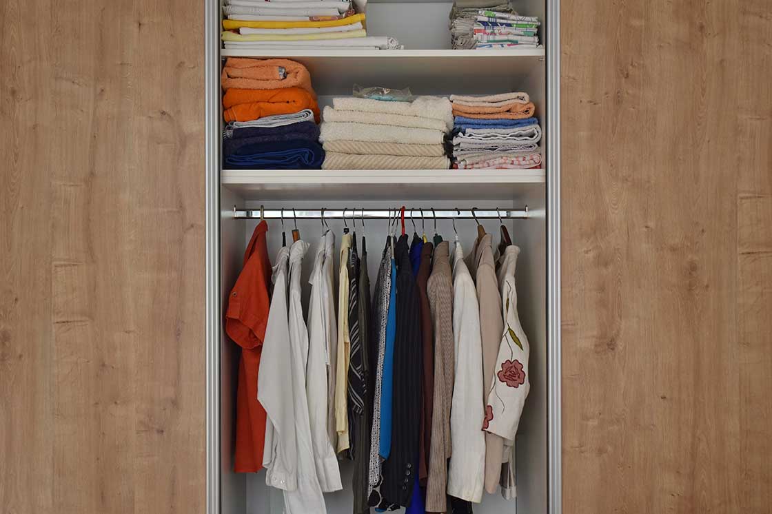 A closet with double hanging rods for increased storage.