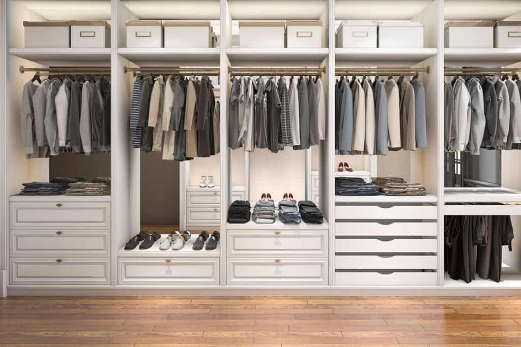 Sleek Walk-in Closet design in Balm, FL with white cabinetry and neatly arranged hanging sections.