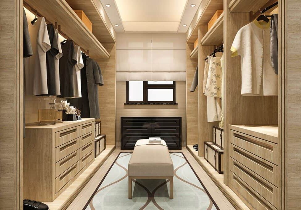 A custom closet featuring seating options, including a stylish bench with hidden storage compartments.